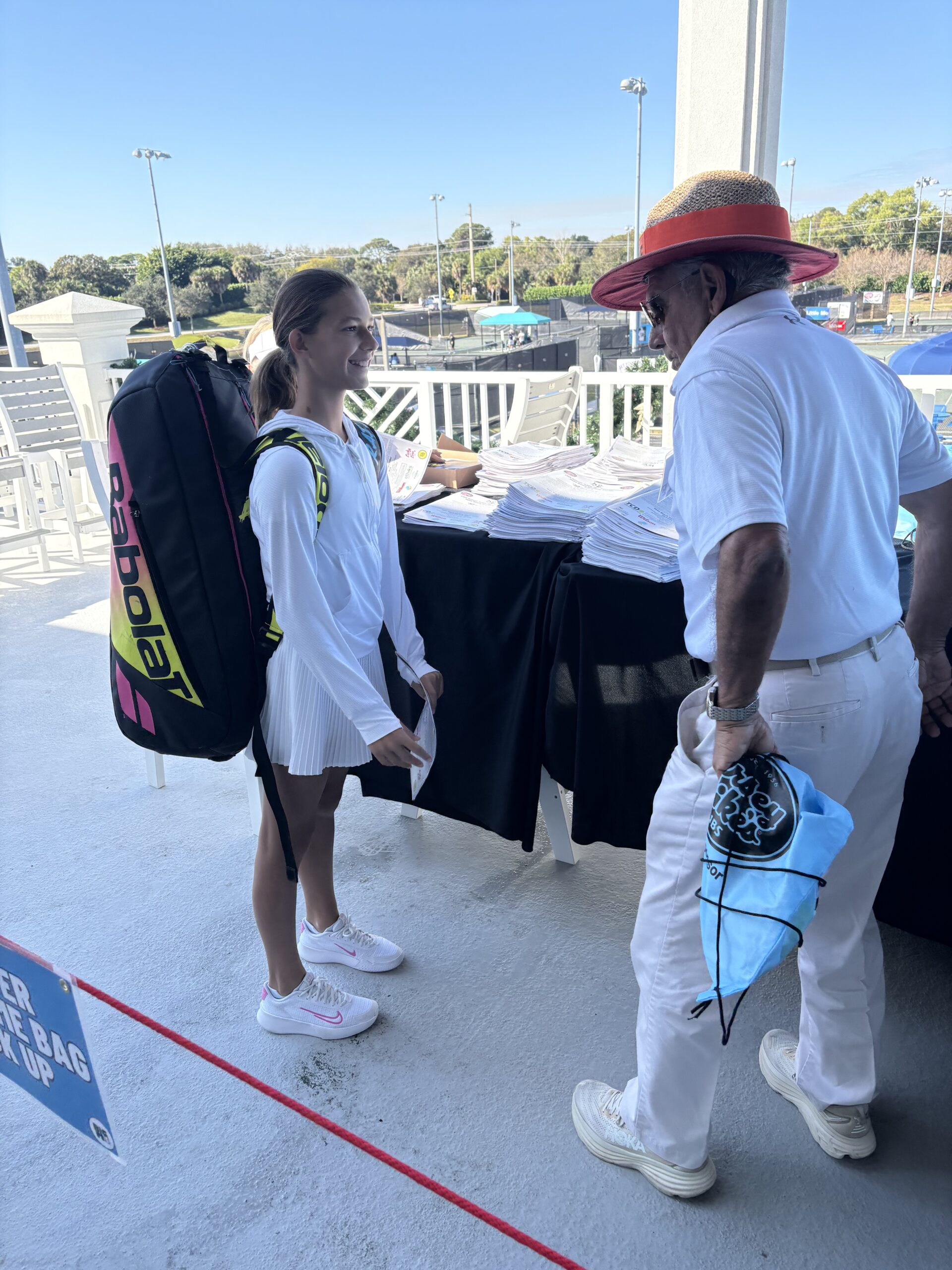 Female tennis player standing and smiling