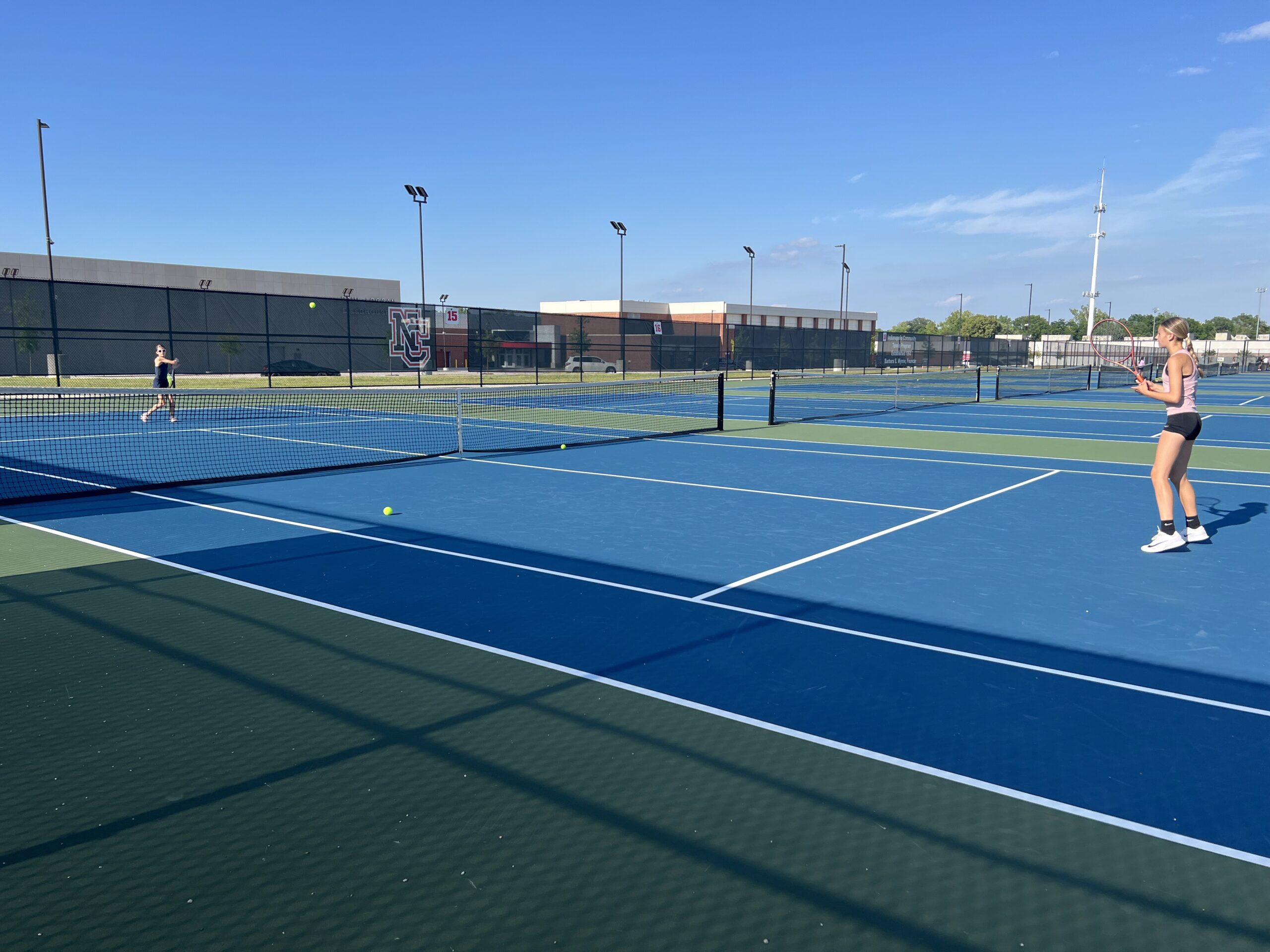 Young female tennis players on court