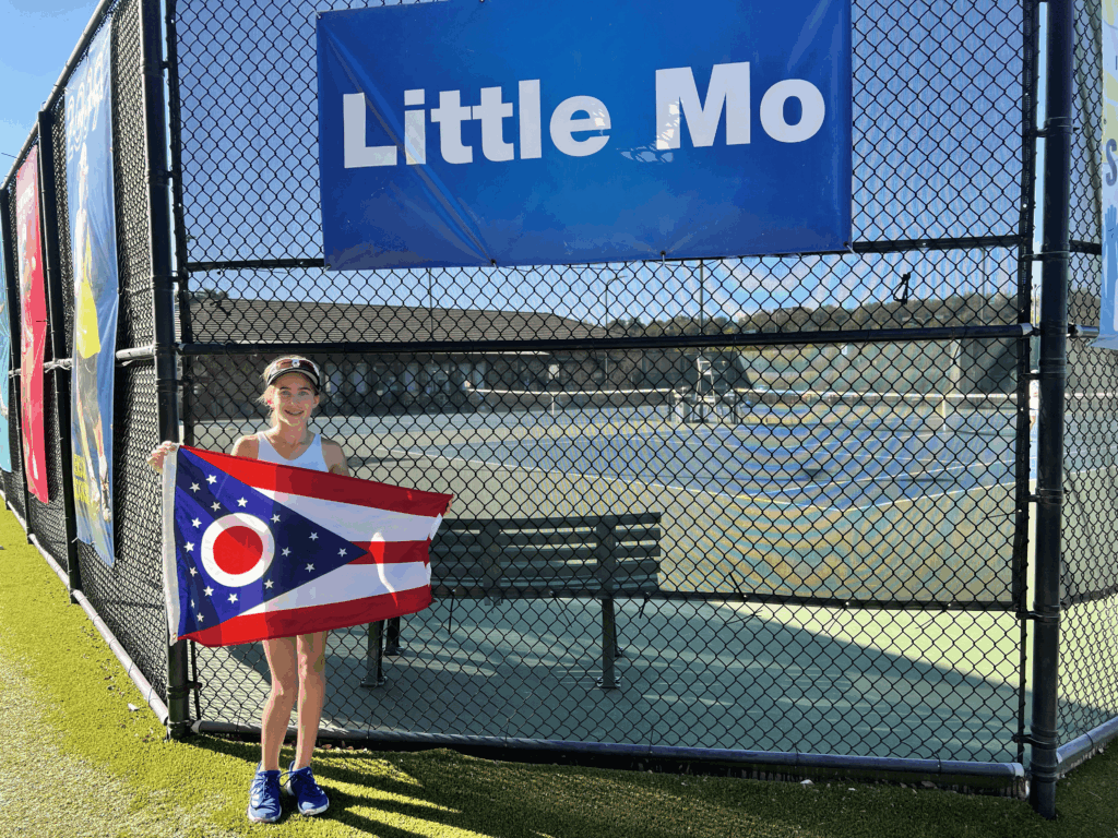 Young tennis player holding ohio flag