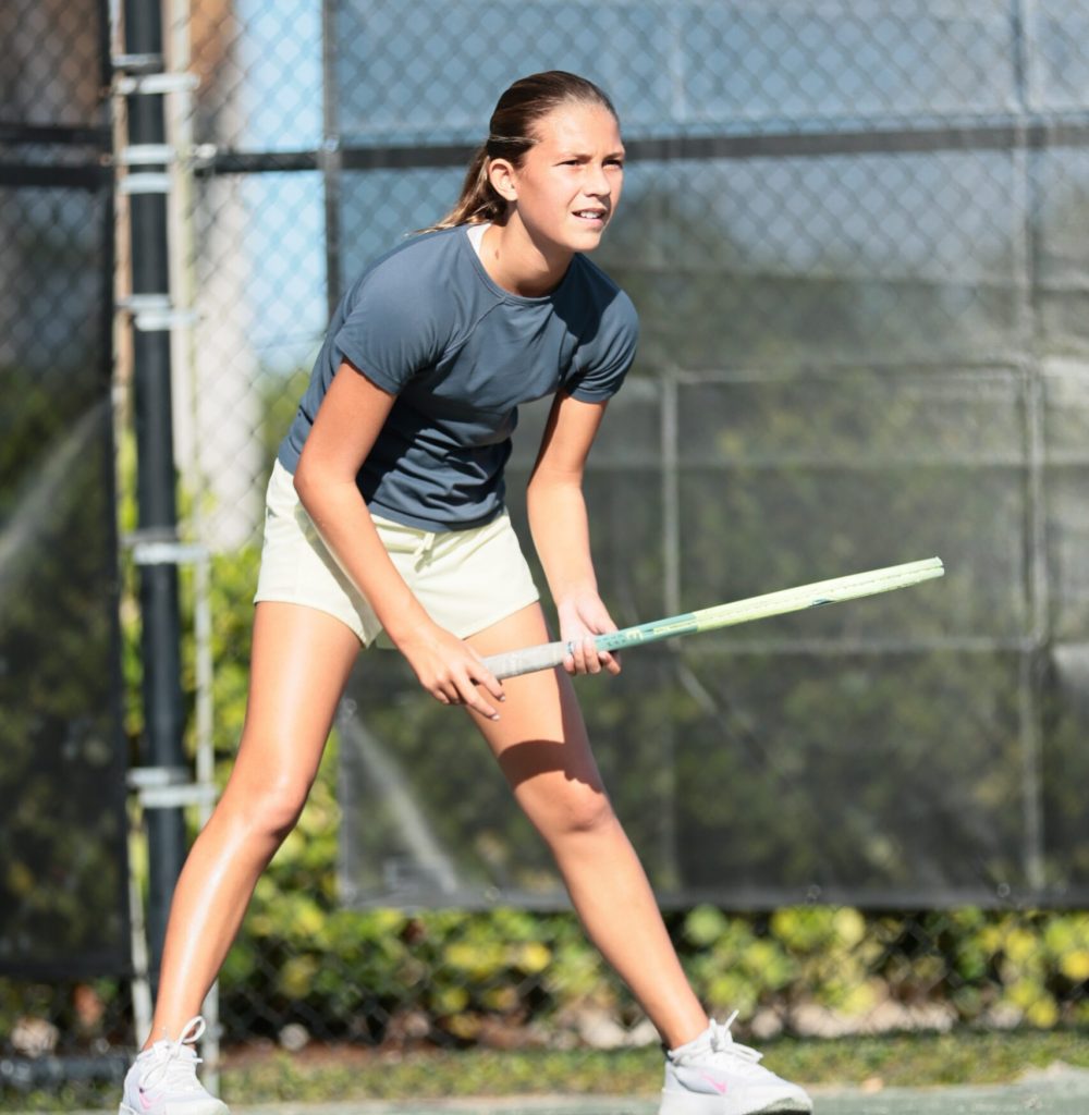 Girl wearing athletic clothing with sun shining bright