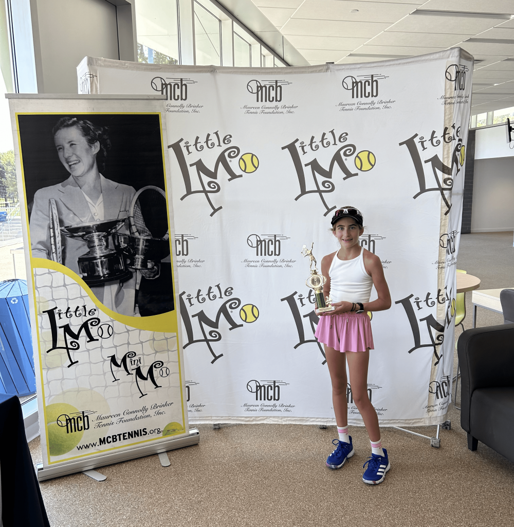 IMG_0551 Female tennis player standing infront of little M sign