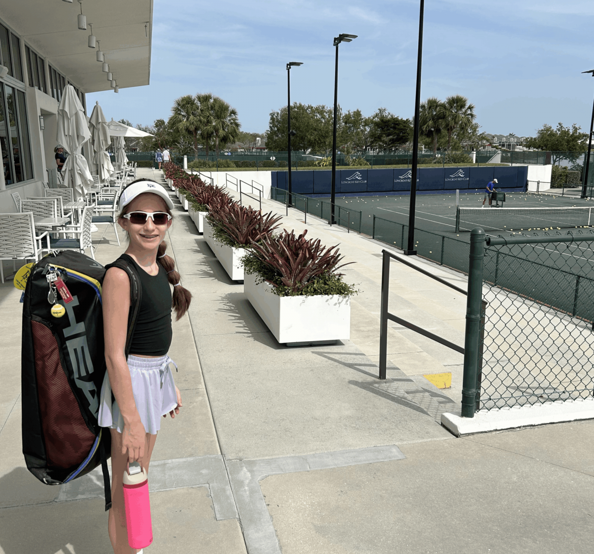 IMG_1944 Girl with visor, sunglasses, and tennis shoes outside