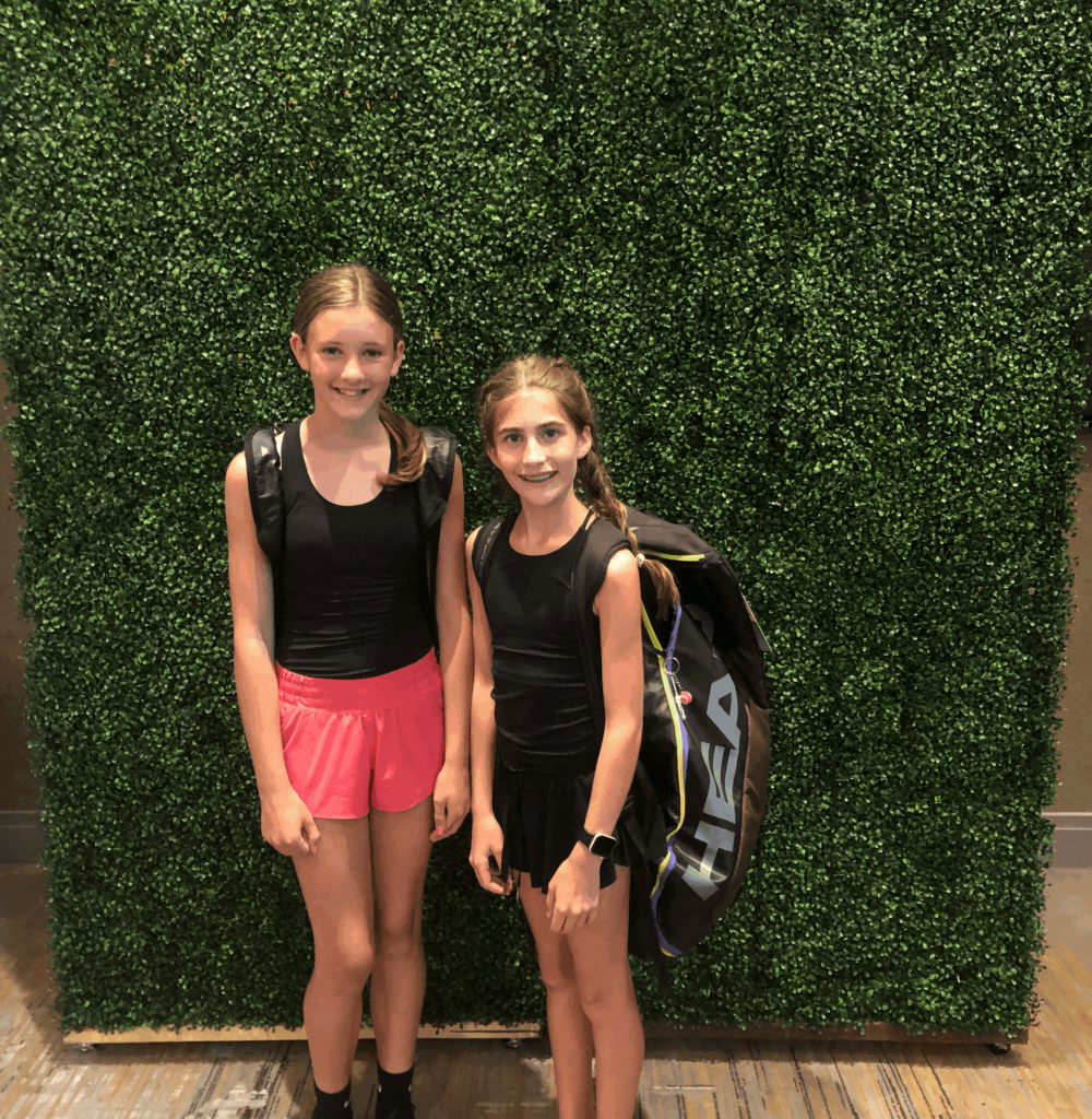 Young female tennis players with tennis shoes and racket bags