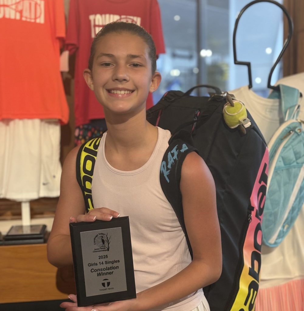 Female tennis player holding award