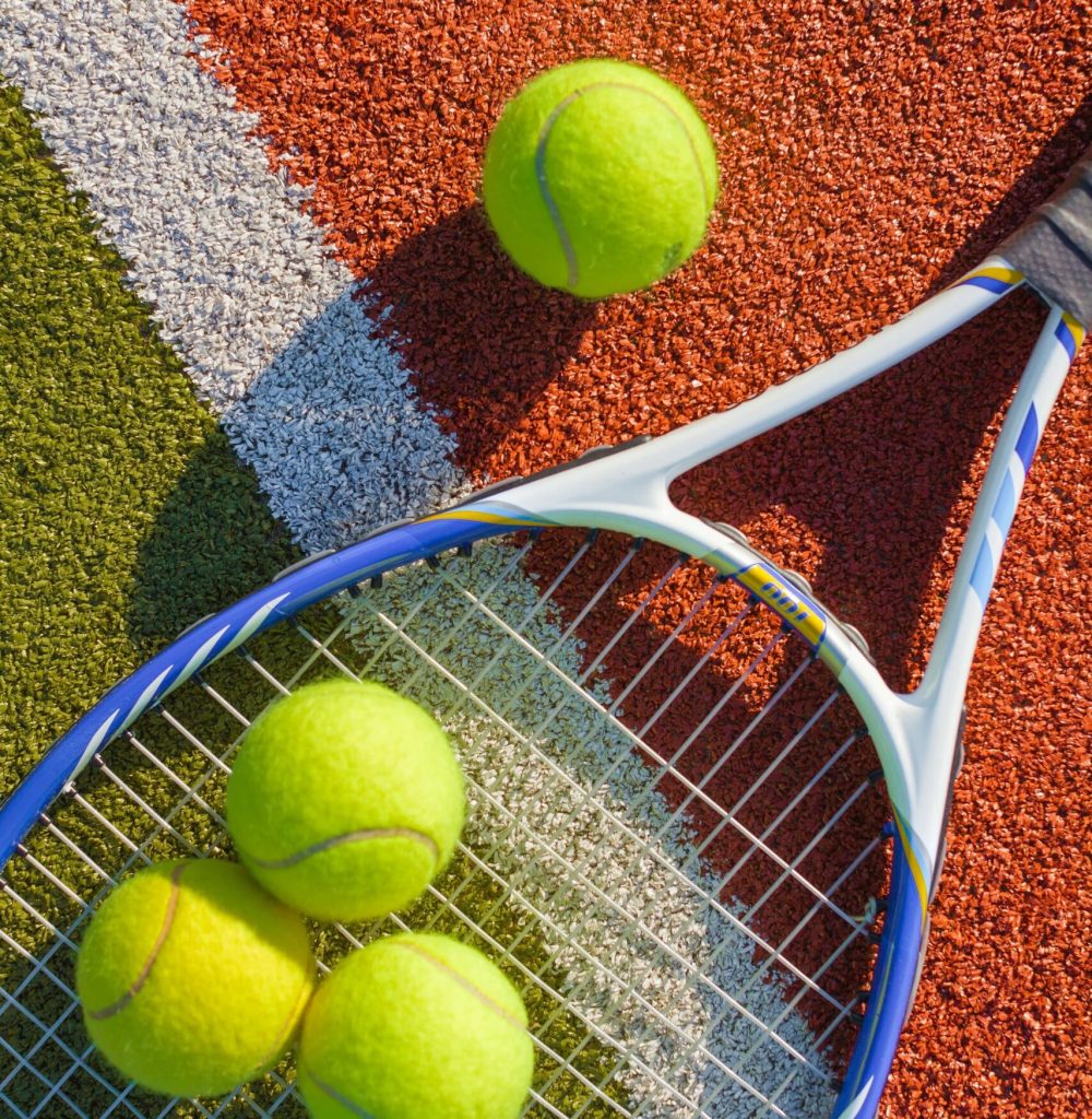 shutterstock_286085735(1)-min Tennis balls and racket on court
